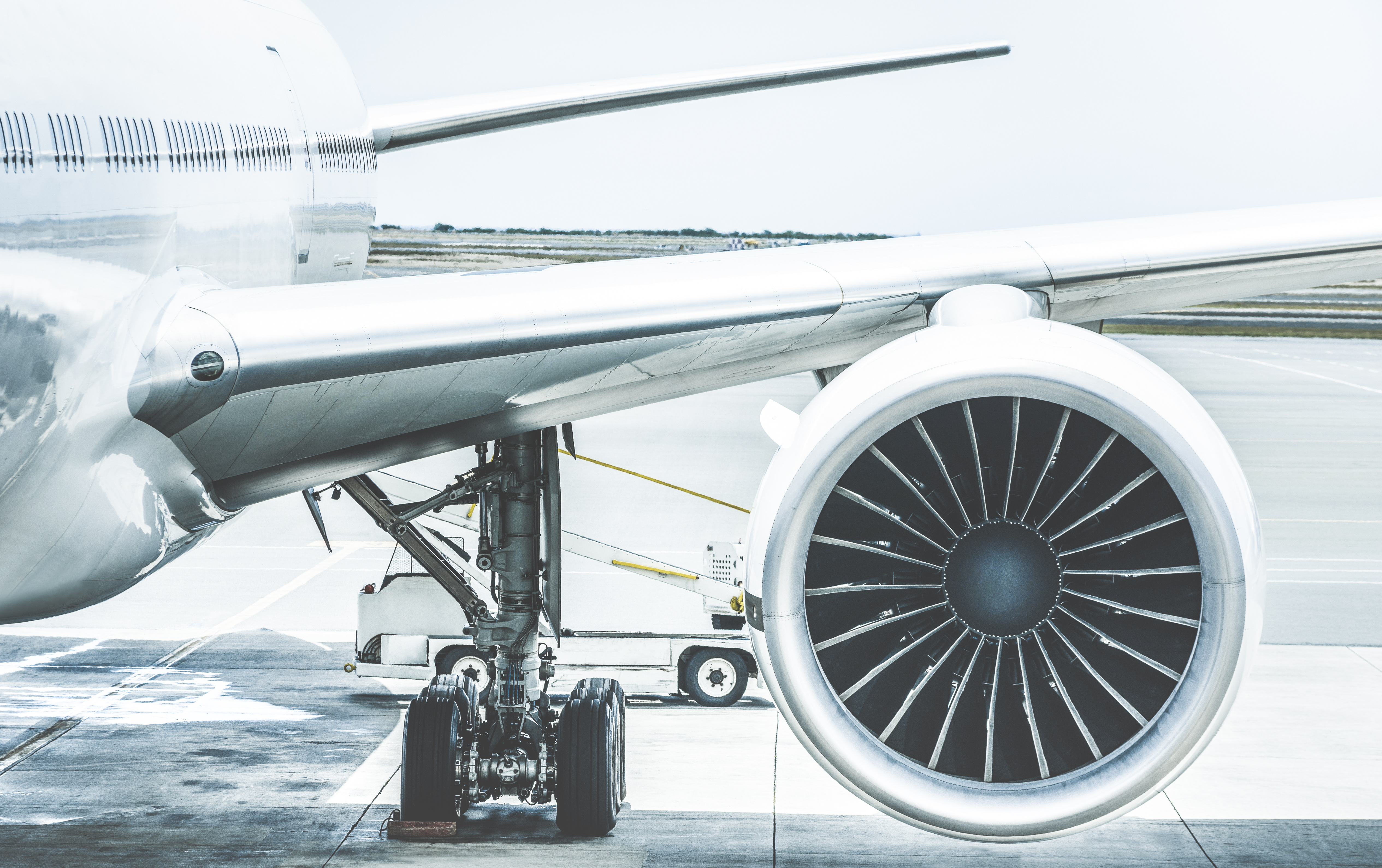 Detail of airplane engine wing at terminal gate before takeoff –